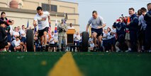 Col.Juris L. Jansons, 8th Fighter Wing vice commander, and Republic of Korea air force Col. Seung Bae Kong, 111th Tiger Squadron commander, compete in a tire rolling competition after the opening ceremony of the Korean and American Friendship Day at Kunsan Air Base, Republic of Korea, Oct. 23, 2015. Members of the 8th FW and ROKAF participated in activities throughout the day to celebrate and strengthen the partnership shared by the ROK and U.S. (U.S. Air Force photo by Staff Sgt. Nick Wilson/Released)  