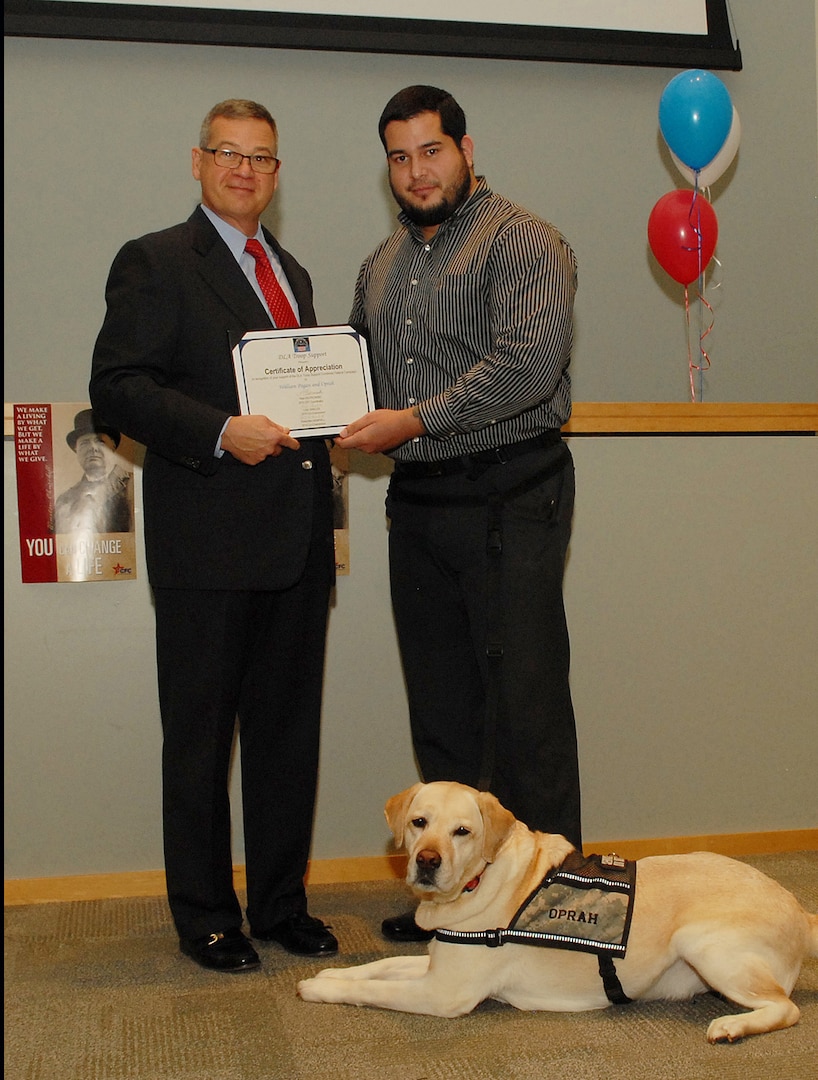 Richard Ellis, DLA Troop Support deputy commander (left) thanks William Pagan (right), a Subsistence TVLS and his service dog, Oprah, for presenting at the DLA Troop Support CFC kickoff Oct. 19 in Philadelphia.
