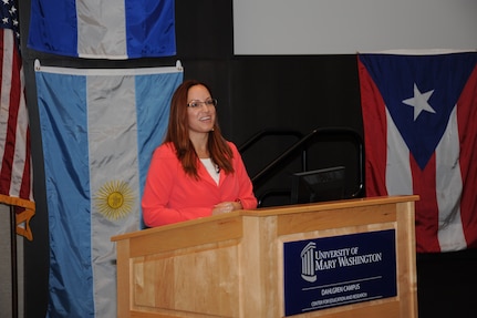 DAHLGREN, Va. - Isha Renta - guest speaker at the Naval Surface Warfare Center Dahlgren Division (NSWCDD) 2015 Hispanic Heritage Observance - tells the audience about her science, technology, engineering, and mathematics (STEM) student outreach that includes the arts.