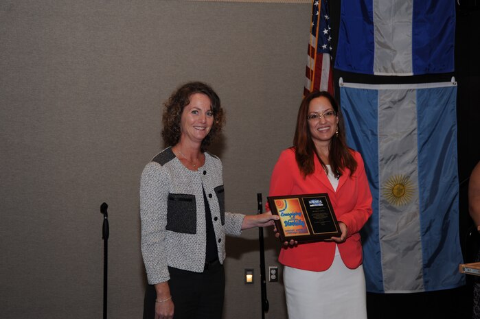 DAHLGREN, Va. - Naval Surface Warfare Center Dahlgren Division (NSWCDD) Chief of Staff Meredith Bondurant presents Isha Renta, a National Oceanic and Atmospheric Administration meteorologist, with a plaque in appreciation of her support to the NSWCDD 2015 Hispanic Heritage Month Observance.