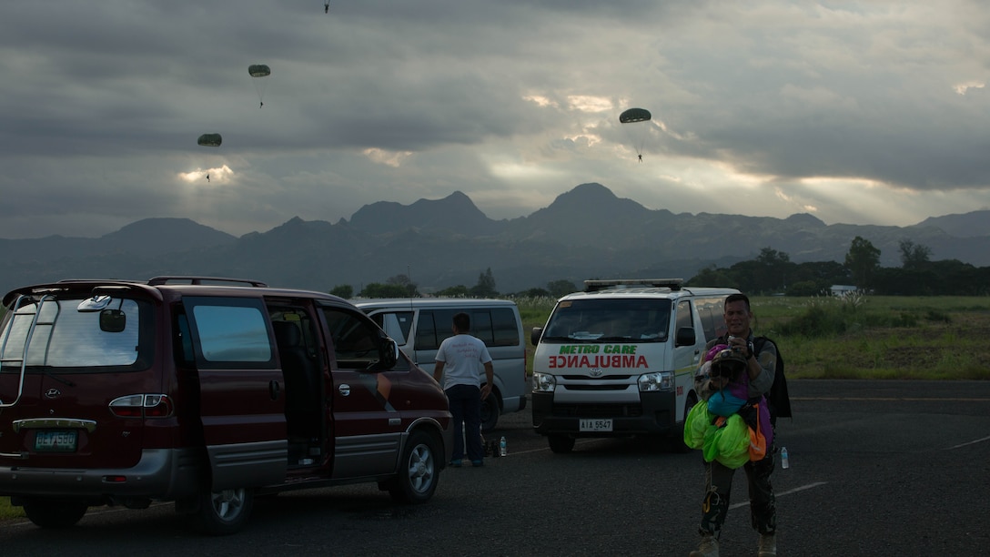 Philippine Army Ranger Master Sgt. Anthony Soriano walks away from the drop zone after a high altitude low opening jump as U.S. Marines parachute down from an MV-22B Osprey tiltrotor aircraft Oct. 5, 2015, as part of Amphibious Landing Exercise 2015 at Basa Air Base, Philippines. PHIBLEX is an annual, bilateral training exercise conducted by members of the Armed Forces of the Philippines alongside U.S. Marine and Navy forces. It focuses on strengthening the partnership and relationships between the two nations across a range of military operations, including disaster relief and complex expeditionary operations. 