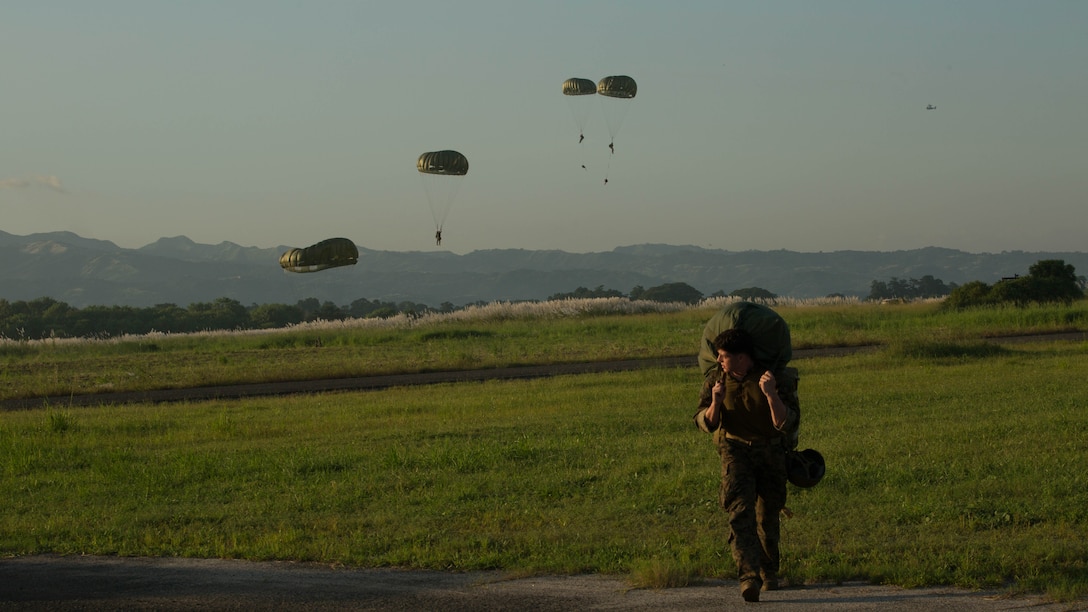 U.S. Marine Lance Cpl. Dylan Loftus walks away from the drop zone after completing a static-line jump during jump operations Oct. 6, 2015, as part of Amphibious Landing Exercise 2015 at Basa Air Base, Philippines.  PHIBLEX is an annual, bilateral training exercise conducted by members of the Armed Forces of the Philippines alongside U.S. Marine and Navy forces. Loftus is a parachute rigger with Maritime Raid Force, 31st Marine Expeditionary Unit.