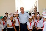 Brig. Gen. Michael E. Stencel, adjutant general, Oregon, poses with students at their new intermediate school in Phu Tinh village in the Quang Nam Province of Vietnam, Oct. 21,  2015, following a ribbon cutting ceremony. The new school was built in cooperation between the U.S. and Vietnam and has a secondary-use as a shelter during natural disasters. 