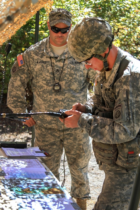 Army Staff Sgt. Douglas Kautz, left, observes Army 1st Lt. Matthew Harrison as he prepares a radio for operation during Expert Infantryman Badge testing on Fort Bragg, N.C., Oct. 14, 2015. Kautz is an infantryman assigned to the 82nd Airborne Division's 1st Battalion, 325th Airborne Infantry Regiment, 2nd Brigade Combat Team, and Harrison is an infantry officer assigned to the Brigade's 1st Squadron, 73rd Cavalry Regiment. U.S. Army photo by Staff Sgt. Jason Hull