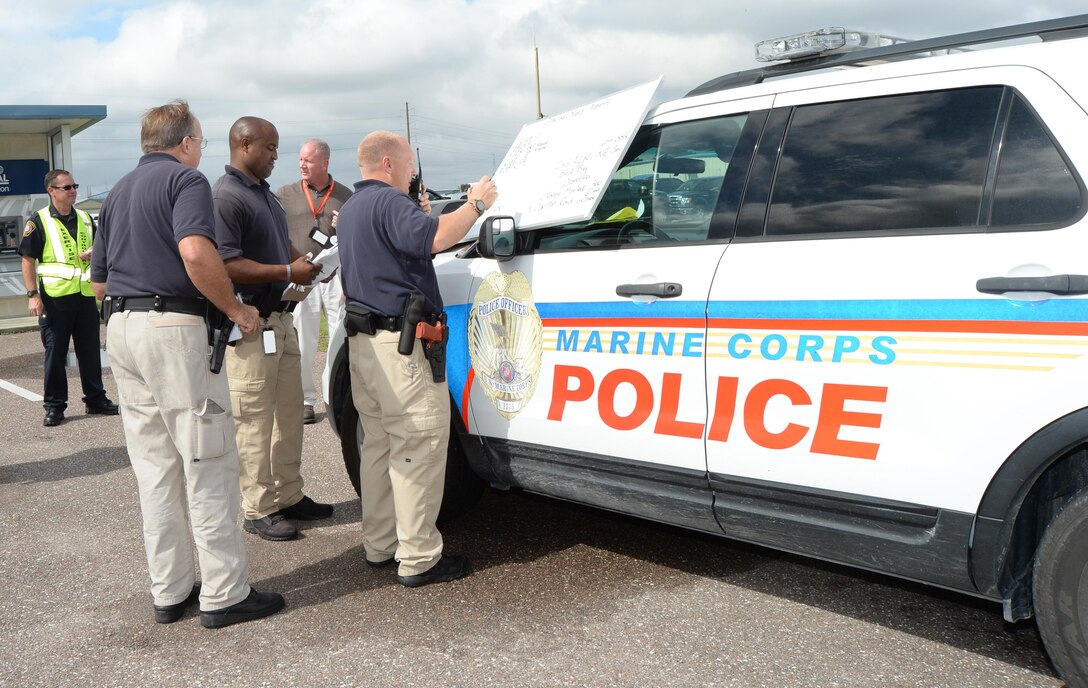 Blount Island Command law enforcement officials at Marine Corps Support Facility Blount Island, Jacksonville, Fla., share information and discuss strategies during a full scale bomb-threat exercise on the base, recently. The exercise was conducted to provide insight on procedures and areas of concern in the event of an actual bomb threat.
