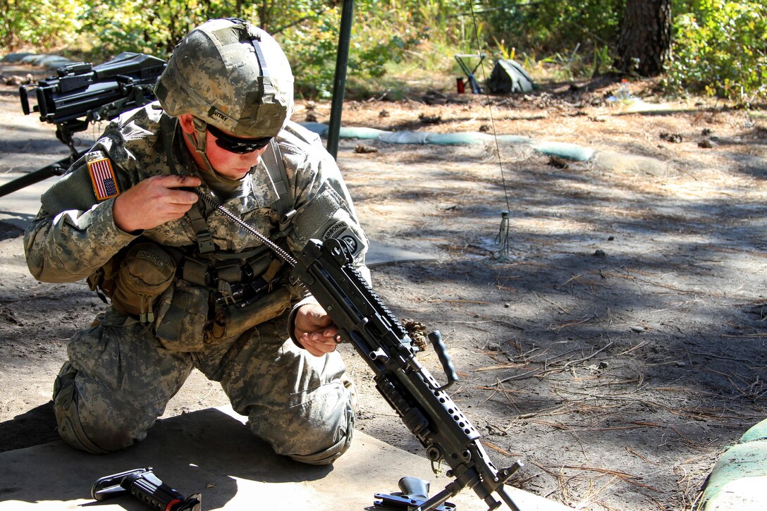 Army Sgt. Benjamin Witry reassembles an M249 light machine gun during Expert Infantryman Badge testing on Fort Bragg, N.C., Oct. 14, 2015. Witry is an infantryman assigned to the 82nd Airborne Division's 1st Battalion, 325th Airborne Infantry Regiment, 2nd Brigade Combat Team. U.S. Army photo by Staff Sgt. Jason Hull