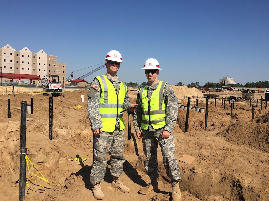 Capt. Joshua Moore (right) and 2nd Lt. Thomas Zarack (left), both part of the Technical Engineer Competency Development Program, pose at the site of Fort Gordon’s $66 million Advanced Individual Training Phase II Barracks and Ground Source Heat Transfer Project Oct. 16. The pair work as part of the TEC-DP which places junior engineers at USACE districts to gain technical expertise while filling key billets within USACE. 