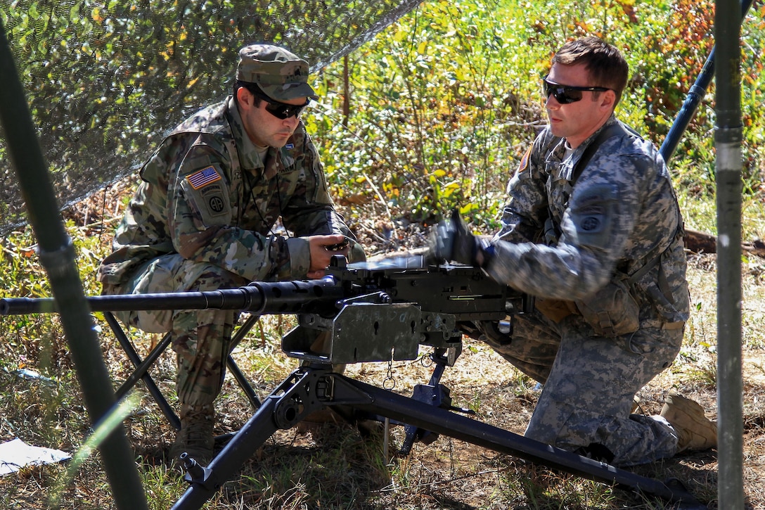 Army 1st Lt. Isaac Lyons, right, practices rapid loading of an M2 machine gun during Expert Infantryman Badge testing on Fort Bragg, N.C., Oct. 14, 2015. Lyons is an infantry officer assigned to the 82nd Airborne Division's 1st Battalion, 325th Airborne Infantry Regiment, 2nd Brigade Combat Team. U.S. Army photo by Staff Sgt. Jason Hull