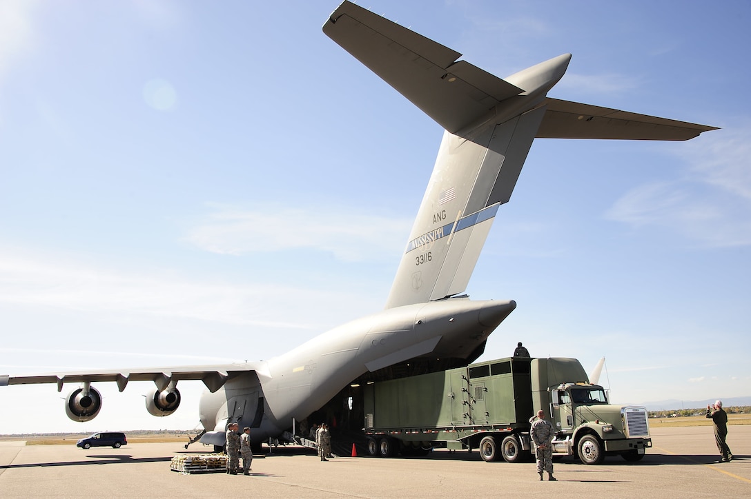 Colorado Air National Guard Airmen from the 233rd Space Group, Greeley Air National Guard Station, Colo., load a Mission Vehicle 118 onto a C-17 Globemaster III at Buckley Air Force Base, Colo., Oct. 17, 2015. (U.S. Air National Guard photo/Tech. Sgt. Nicole Manzanares)