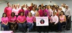 Defense Logistics Agency Energy Aerospace Energy employees pose for a photograph during a breast cancer awareness event held in San Antonio, Oct. 22. Two breast cancer survivors spoke at the event, and a poster was made in memory of an employee, Sylvia Gonzales, who lost her battle to breast cancer in 2010.