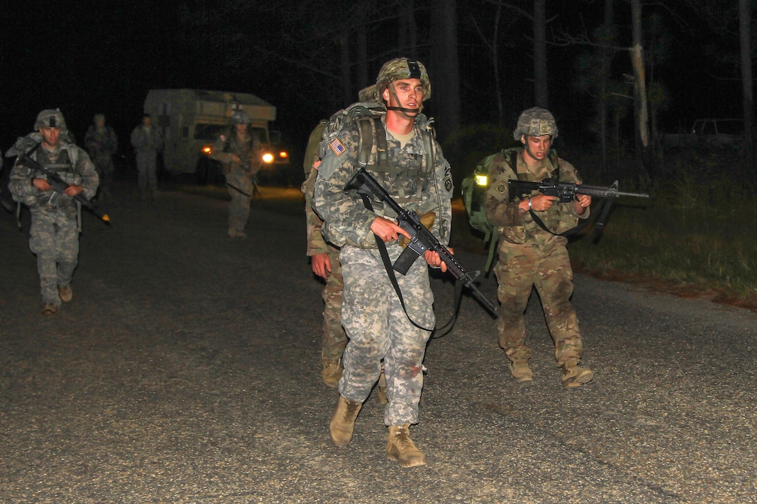 Paratroopers participate in a timed, 12-mile tactical foot march during Expert Infantryman Badge testing on Fort Bragg, N.C., Oct. 16, 2015. U.S. Army photo by Staff Sgt. Jason Hull