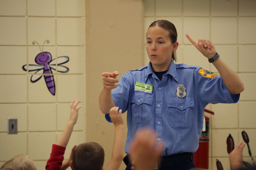 Brandee Ridgway discusses fire safety with students during a visit to W. J. Gurganus Elementary School in Havelock, N.C., Oct. 22, 2015. Members of the Marine Corps Air Station Cherry Point Fire and Emergency Services Department visited the local elementary school to teach children about the importance of fire safety and prevention. The air station fire department actively participates in school visits to encourage children of all ages to practice safety measures to keep both their families and themselves safe. Ridgway is a fire inspector with the MCAS Cherry Point Fire and Emergency Services Department. (U.S. Marine Corps photo by Cpl. N.W. Huertas/Released)