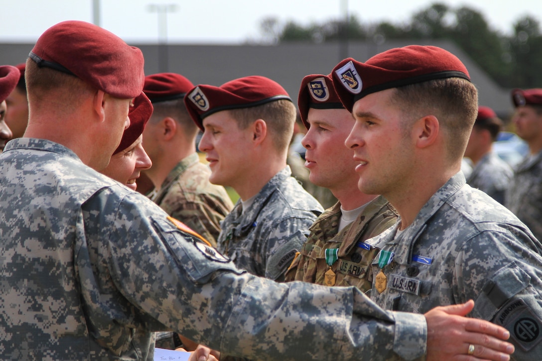 Paratroopers receive the Expert Infantryman Badge and an Army Commendation Medal for achieving "true blue," meaning they completed all phases of testing without a single failure, or "no go," on Fort Bragg, N.C., Oct. 16, 2015. U.S. Army photo by Staff Sgt. Jason Hull