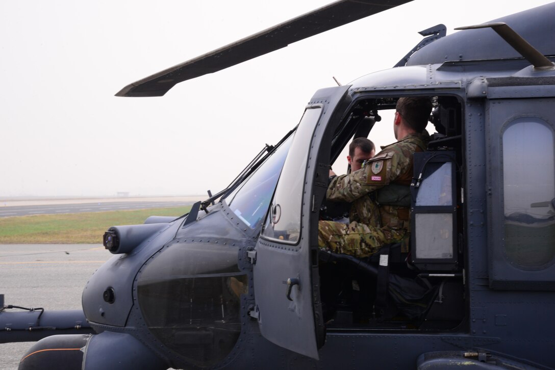 Members of the 33rd Rescue Squadron prepare for takeoff inside their HH-60G Pave Hawk Oct. 16, 2015, at Osan Air Base, South Korea. The 33rd RQS members are from Kadena Air Base, Japan, and are participating in exercise Pacific Thunder 15-02. (U.S. Air Force photo/Staff Sgt. Benjamin Sutton)
