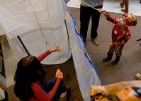 ALTUS AIR FORCE BASE, Okla. – A child fishes for a snack during a deployed family dinner at the Freedom Community Center, Oct. 22, 2015. The dinner is held quarterly for family members of deployed Airmen. There were various activities for children to participate in such as cornhole, fishing, pumpkin carving and rubber duck racing. (U.S. Air Force photo by Senior Airman Franklin R. Ramos/Released)
