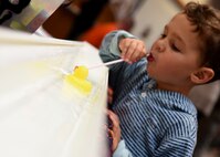 ALTUS AIR FORCE BASE, Okla. – A child participates in a rubber duck race during a deployed family dinner at the Freedom Community Center, Oct. 22, 2015. The dinner is held quarterly for family members of deployed Airmen. There were various activities for children to participate in such as corn hole, fishing, pumpkin carving and rubber duck racing. (U.S. Air Force photo by Senior Airman Franklin R. Ramos/Released)