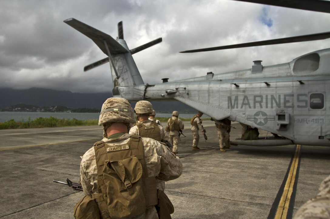 Marines board a CH-53E Super Stallion helicopter in preparation for an air-ground task force demonstration at the Kaneohe Bay Air Show on Marine Corps Base Hawaii, Oct. 18, 2015. U.S. Marine Corps photo by Lance Cpl. Aaron S. Patterson