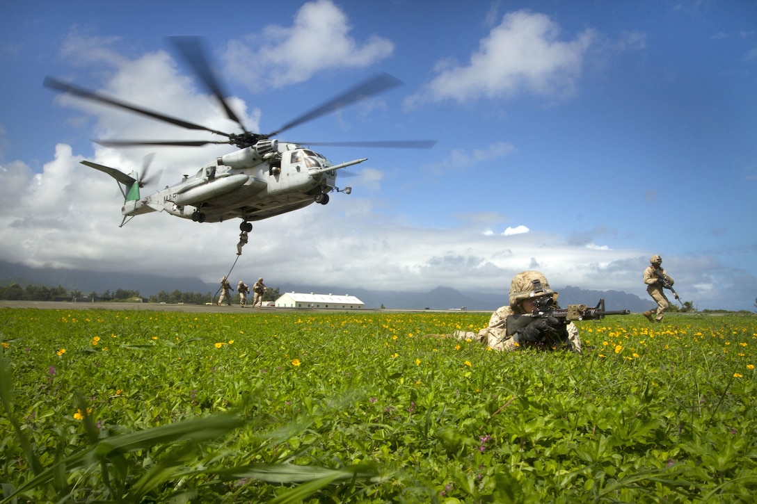 Marines guard a helicopter landing zone during an Air-Ground Task Force demonstration at the Kaneohe Bay Air Show on Marine Corps Air Station Kaneohe Bay in Hawaii, Oct. 18, 2015. U.S. Marine Corps photo by Lance Cpl. Aaron S. Patterson  