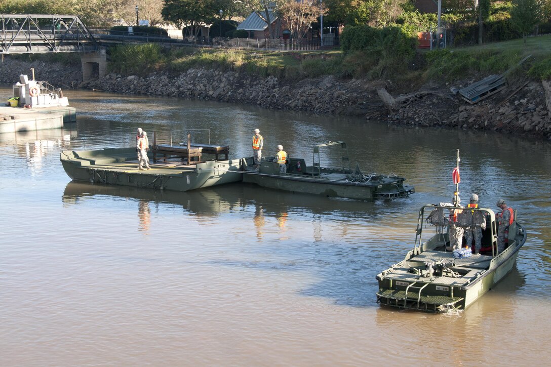 South Carolina Army National Guardsmen operate watercraft boats to help local contractors remove a heavy steel plate out of the canal in Columbia S.C., Oct. 21 2015, after historic statewide flooding in early October. South Carolina Army National Guard Photo by 2nd Lt. Tracci Dorgan