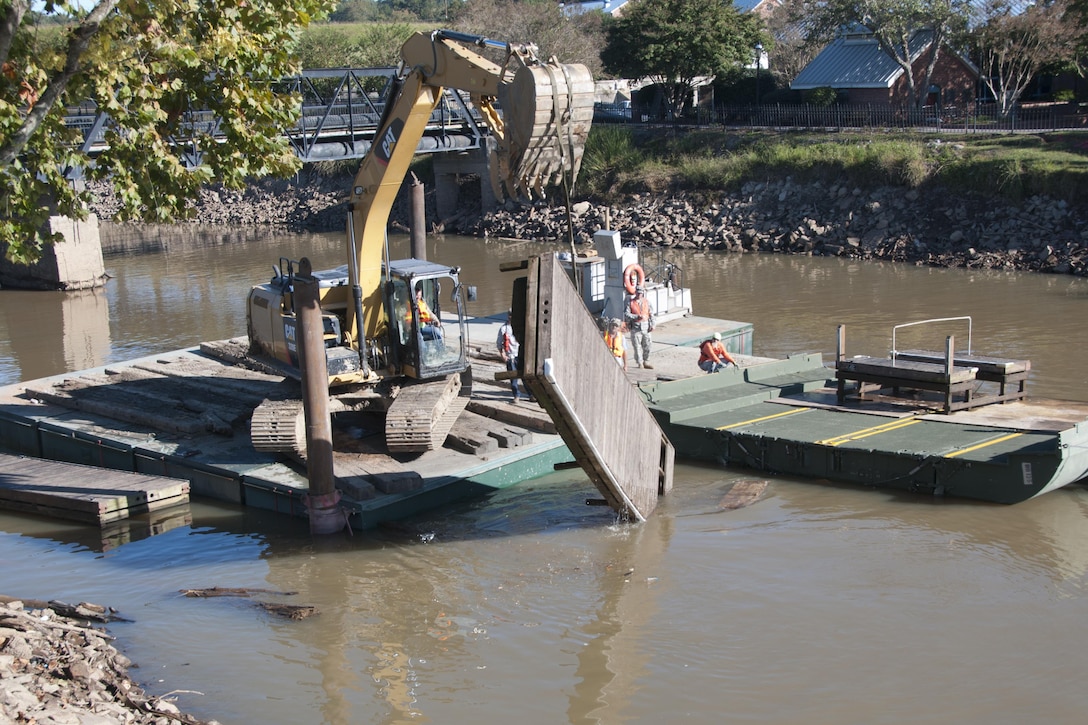 South Carolina Army National Guardsmen help local contractors remove a large obstacle out of the canal in Columbia S.C., Oct. 21 2015, after historic statewide flooding in early October. South Carolina Army National Guard Photo by 2nd Lt. Tracci Dorgan