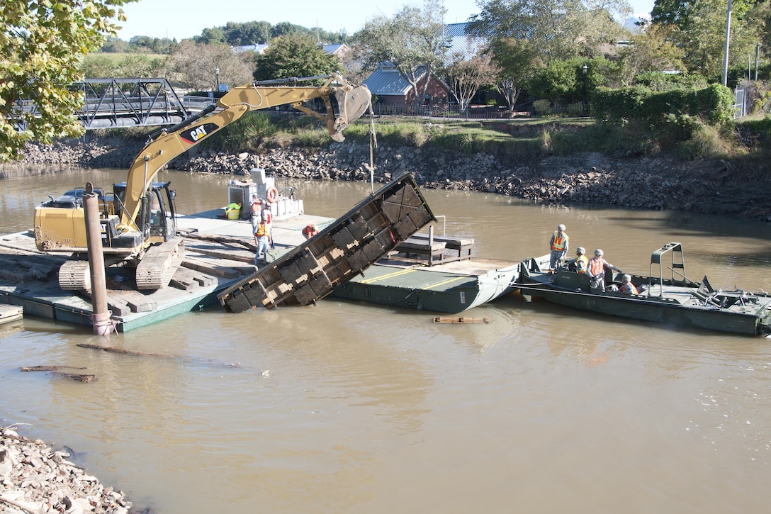 South Carolina Army National Guardsmen operating a watercraft boat help local contractors remove a large obstacle out of the canal in Columbia S.C., Oct. 21 2015, after historic statewide flooding in early October. South Carolina Army National Guard Photo by 2nd Lt. Tracci Dorgan