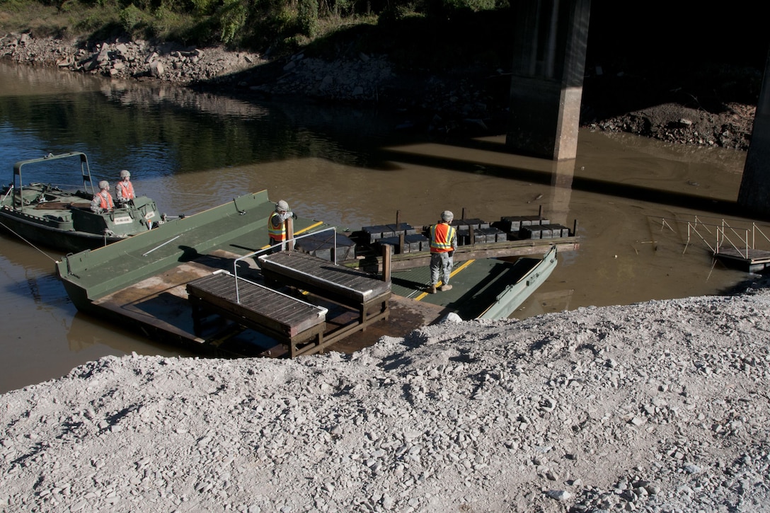 South Carolina Army National Guardsmen operate watercraft boats to help local contractors remove a small metal bridge out of the canal in Columbia S.C., Oct. 21 2015, after historic statewide flooding in early October. South Carolina Army National Guard Photo by 2nd Lt. Tracci Dorgan