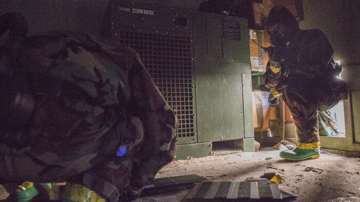 Marines with Explosive Ordnance Disposal Company, 8th Engineer Support Battalion, prepare to X-ray the inside of a device during a field exercise at Marine Corps Base Camp Lejeune, N.C., Oct. 21, 2015. The unit simulated neutralizing a device containing a deadly nerve agent in a contaminated area before it was dispersed to the public.