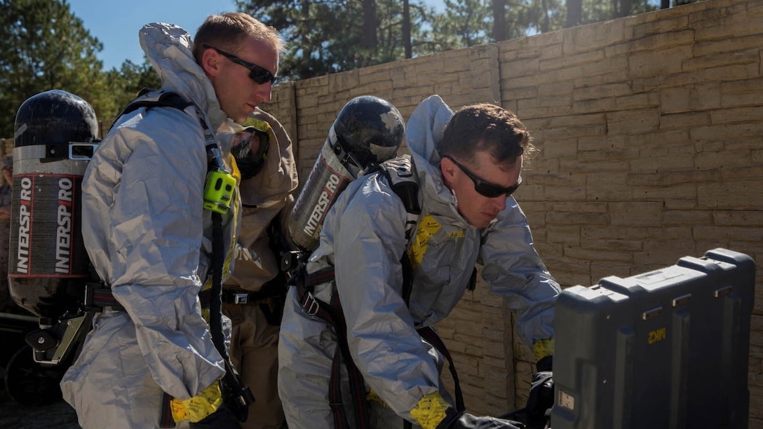 Marines with Explosive Ordnance Disposal Company, 8th Engineer Support Battalion, control a Man Transportable Robotics System MK2 Talon during a company field exercise at Camp Lejeune, N.C., Oct. 21, 2015. The MK2 Talon allows the Marines to enter a dangerous environment remotely to assess the situation. The unit simulated neutralizing a device containing a deadly nerve agent in a contaminated area before it was dispersed to the public.