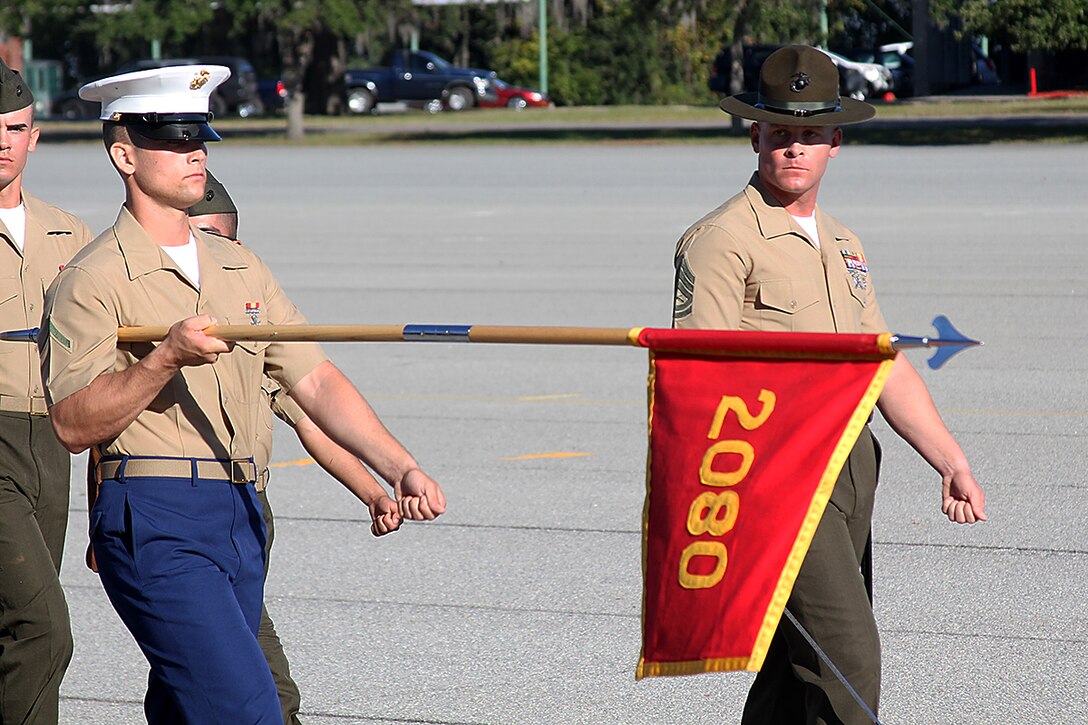 Pfc. Matthew L. Hudson, honor graduate of platoon 2080, presents his guidon during the pass and review portion of graduation Oct. 23, 2015 at Marine Corps Recruit Depot Parris Island, S.C. Hudson, a native of Spartanburg, S.C., was recruited by Sgt. Cory A. Brown at Recruiting Substation Spartanburg, Recruiting Station Columbia. To be recommended as an honor graduate, a recruit must not only display honor, courage, and commitment during their three months of training but excel in physical training, knowledge, and have a team player disposition. (Official Marine Corps photo by Cpl. Diamond Peden)