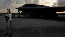 Senior Airman Jeico Sanchez-Arias, 509th Security Forces Squadron security journeyman, guards a B-2 Spirit on the flightline at Andersen Air Force Base, Guam, Aug. 12, 2015. Airmen and B-2 Spirits from the 13th Bomb Squadron, Whiteman Air Force Base, Missouri, are deployed to Guam to conduct familiarization training activities in the Pacific (U.S. Air Force photo by Senior Airman Joseph A. Pagán Jr./Released)