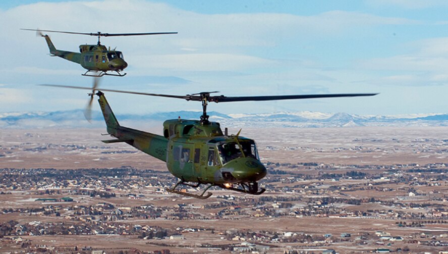 Two UH-1N helicopters from the 37th Helicopter fly over Cheyenne, Wyo.