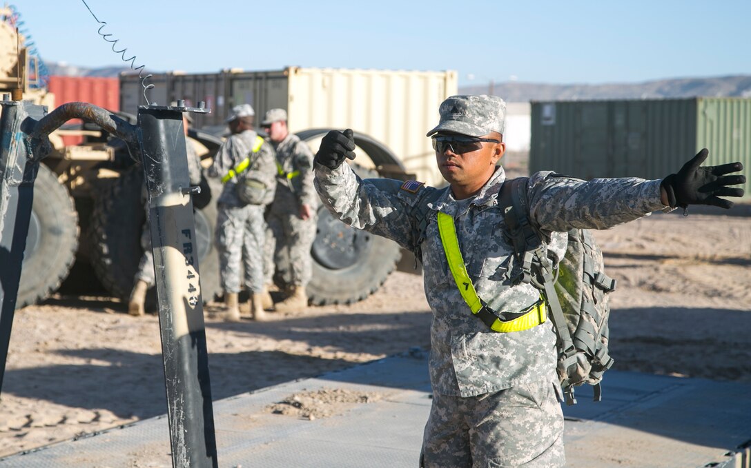 A soldier guides a vehicle into a convoy during Exercise Decisive Action Rotation 16-01 on Fort Irwin, Calif., Oct. 9, 2015. The soldier is assigned to the 1st Cavalry Division’s 1st Brigade Combat Team. U.S. Army photo by Sgt. Richard W. Jones Jr.