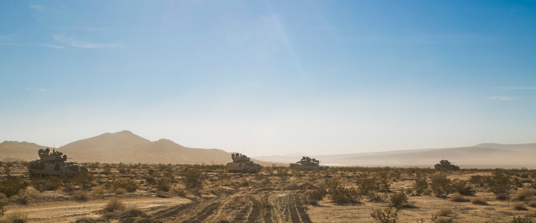 Soldiers manning their M1A1 Abrams tank and M2 Fighting Bradley vehicles provide security during Decisive Action Rotation 16-01 on Fort Irwin, Calif., Oct. 9, 2015. U.S. Army photo by Sgt. Richard W. Jones Jr.