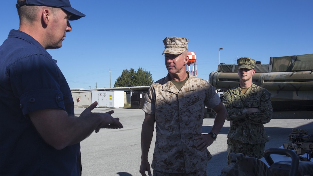 U.S. Marine Corps Brig. Gen Eric Smith, commander of U.S. Marine Forces-South, speaks to leaders of the Special Missions Training Center during the Belize Delegation visit to Marine Corps Base Camp Lejeune, N.C., Oct. 22, 2015. The purpose of the visit was to assess the capabilities of U.S. forces, discern opportunities for Belize forces to train alongside Marines and sustain enduring partnerships between the two countries in their efforts to counter transnational organized crime. (From left to right: U.S. Coast Guard Cmdr. Matthew Baer, executive officer of the Special Missions Training Center; U.S. Marine Corps Brig. Gen. Eric Smith, commander of U.S. Marine Forces-South; U.S Navy Lt. Kerry Michaud, officer-in-charge for the Center for Security Forces Learning Site Camp Lejeune.) 