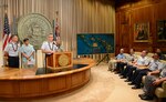 Capt. James Jenkins, Coast Guard 14th District chief of staff, provides remarks after David Ige, Hawaii state governor, read a proclamation announcing the completion of the Anuenue Interisland Digital Microwave Network, at the Hawaii State Capitol in Honolulu, Oct. 22, 2015. Twelve Anuenue “high sites” located on mountaintops in many at remote locations connect with eight sites located at state office buildings and Coast Guard properties. 