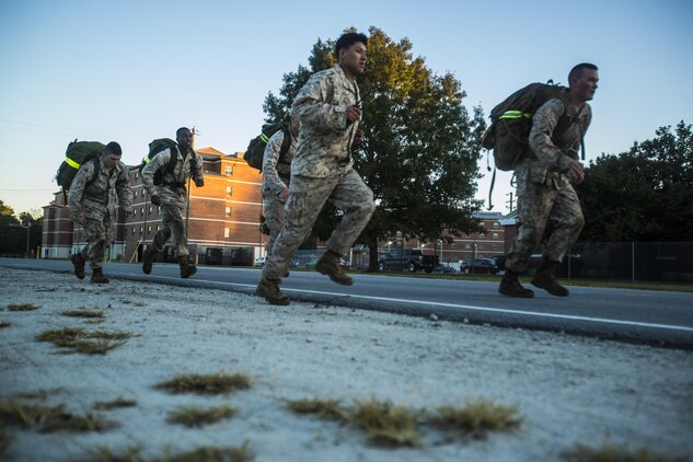 Scout sniper screener candidates with 3rd Battalion, 6th Marine Regiment run with packs weighing approximately 45 pounds during a physical fitness assessment at Camp Lejeune, N.C., Oct. 20, 2015. The screener aims to prepare candidates for the Scout Sniper Basic Course. (U.S. Marine Corps photo by Cpl. Kirstin Merrimarahajara/ released)