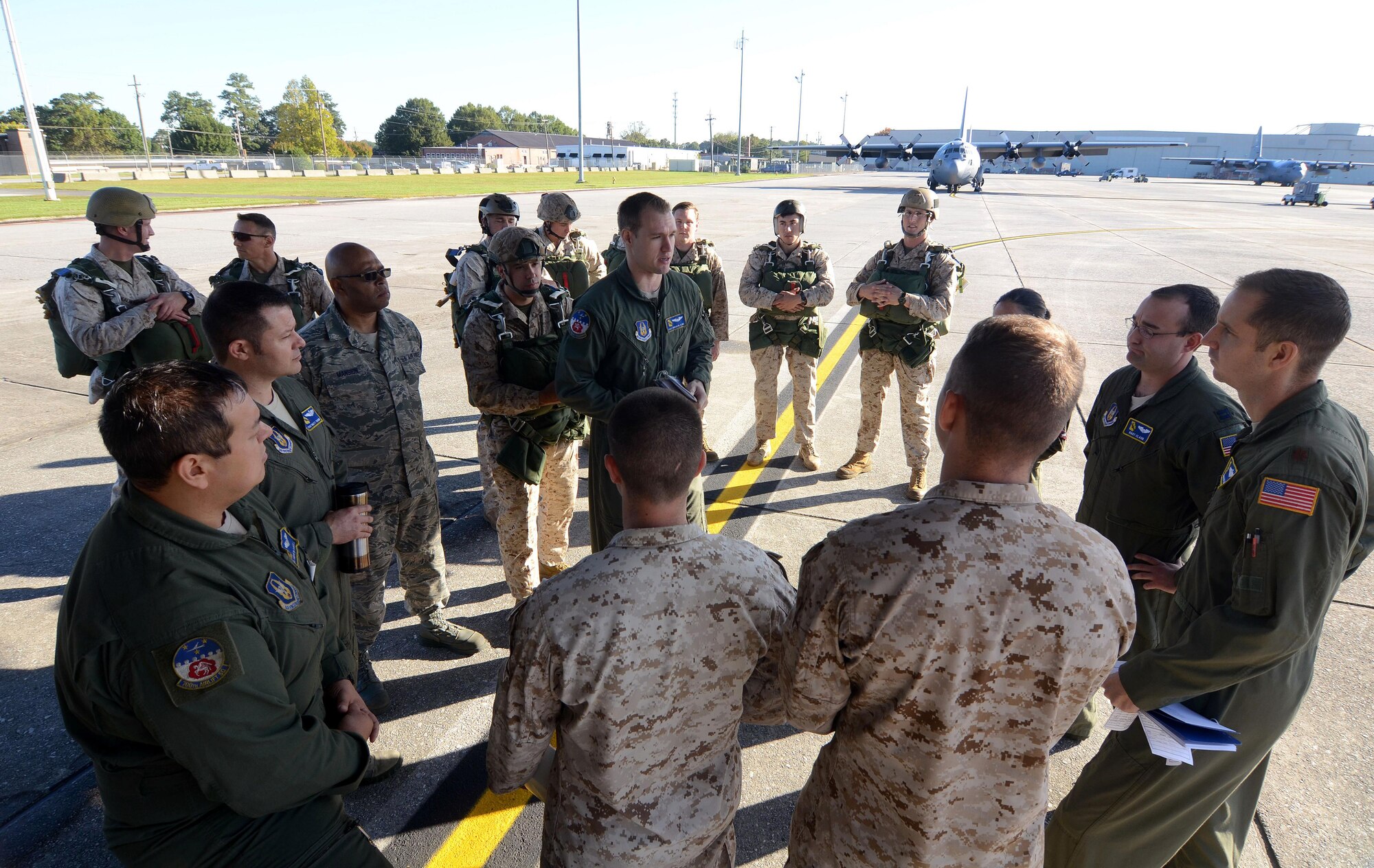 Marines from Bravo Company, 4th Recon Battalion, 4th Marine Division, Marine Forces Reserve, based in Smyrna, Ga., brief with aircrew members from the 94th Airlift Wing at Dobbins Air Reserve Base, Ga., Oct 15, 2015.  The Marines were performing static line parachute recertification jumps to a landing zone on Dobbins ARB. (U.S. Air Force photo/ Don Peek)