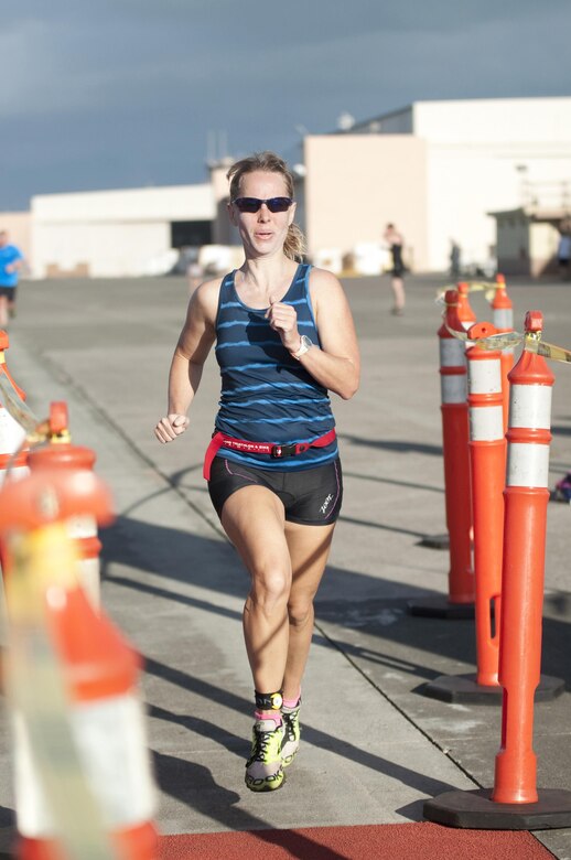 Race participant Heather Barnhill enters the finish line during the Splash & Dash Biathlon aboard Marine Corps Base Hawaii, Oct. 3, 2015. A joint effort by Marine Corps Community Services Hawaii and Helicopter Maritime Strike Squadron 37, the biathlon was the second to last race in the 2015 Commanding Officer’s Fitness Series. A portion of the net profits went to the squadron’s unit fund. Part of MCCS Hawaii’s mission is to contribute to the retention of Marines, Sailors and family members aboard MCB Hawaii by offering fitness programs and races such as the Splash & Dash Biathlon in garrison and deployed environments. (U.S. Marine Corps photo by Kristen Wong) 