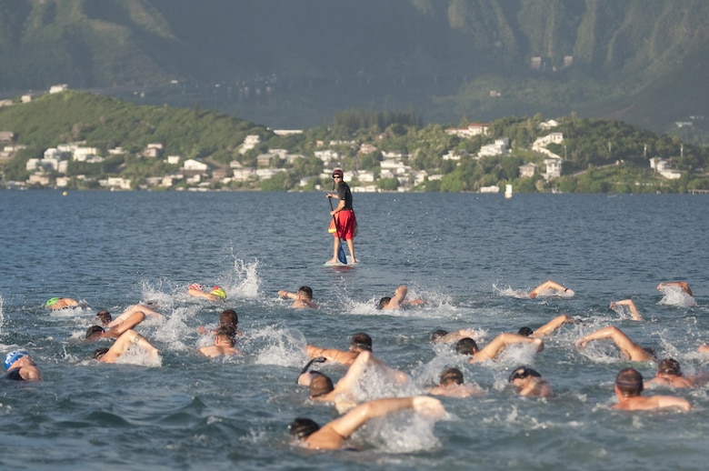 The male competitors swim out into Kaneohe Bay first during the 12th annual Splash & Dash Biathlon aboard Marine Corps Base Hawaii, Oct. 3, 2015. A joint effort by Marine Corps Community Services Hawaii and Helicopter Maritime Strike Squadron 37, the biathlon was the second to last race in the 2015 Commanding Officer’s Fitness Series. A portion of the net profits went to the squadron’s unit fund. Part of MCCS Hawaii’s mission is to contribute to the retention of Marines, Sailors and family members aboard MCB Hawaii by offering fitness programs and races such as the Splash & Dash Biathlon in garrison and deployed environments. (U.S. Marine Corps photo by Kristen Wong)   