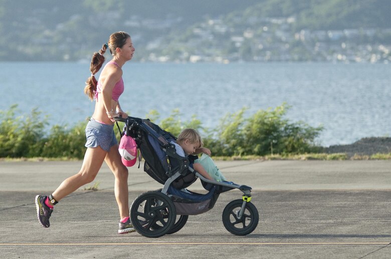 Alissa Rogers, of Kailua, Hawaii, runs in the 12th annual Splash & Dash Biathlon with her son aboard Marine Corps Base Hawaii, Oct. 3, 2015. A joint effort by Marine Corps Community Services Hawaii and Helicopter Maritime Strike Squadron 37, the biathlon was the second to last race in the 2015 Commanding Officer’s Fitness Series. A portion of the net profits went to the squadron’s unit fund. Part of MCCS Hawaii’s mission is to contribute to the retention of Marines, Sailors and family members aboard MCB Hawaii by offering fitness programs and races such as the Splash & Dash Biathlon in garrison and deployed environments. (U.S. Marine Corps photo by Kristen Wong)   