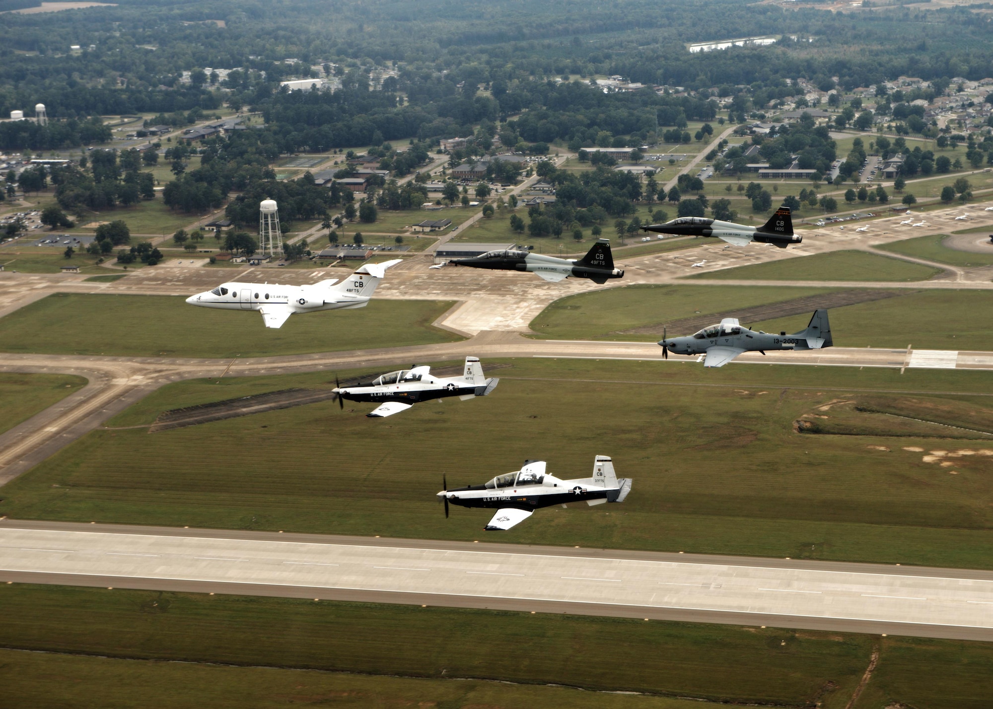 An aircraft from each of the 14th Flying Training Wing flying squadrons were represented in a dissimilar formation above Columbus Air Force Base, Mississippi Oct.1, 2015. The formation flight was performed to showcase the capability of Columbus’ aircraft to incorporate the A-29 into a formation of six aircraft. (U.S. Air Force photo/Airman 1st Class Daniel Lile)