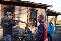 Airmen from Malmstrom Air Force Base and federal employees volunteer to perform household chores and install smoke detectors for the Day of Caring Oct. 23, 2015, in the Great Falls, Mont., community. A total of 300 homes were visited where household chores were performed, with 250 of those homes receiving smoke alarm installations and maintenance. (U.S. Air Force photo/Airman 1st Class Magen M. Reeves)