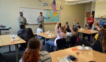 Tech. Sgt. Abifarin Scott (left) and Staff Sgt. Francis Goodwin, both from the 2nd Space Operations Squadron, speak to seventh and eighth grade students  about the Global Positioning System and military service during a Career Café event at Ellicott Middle School in Ellicott, Colorado, Thursday, Oct. 22, 2015. Scott and Goodwin were able to clear up misperceptions about the military during their presentation. (U.S. Air Force photo/Staff Sgt. Debbie Lockhart) 