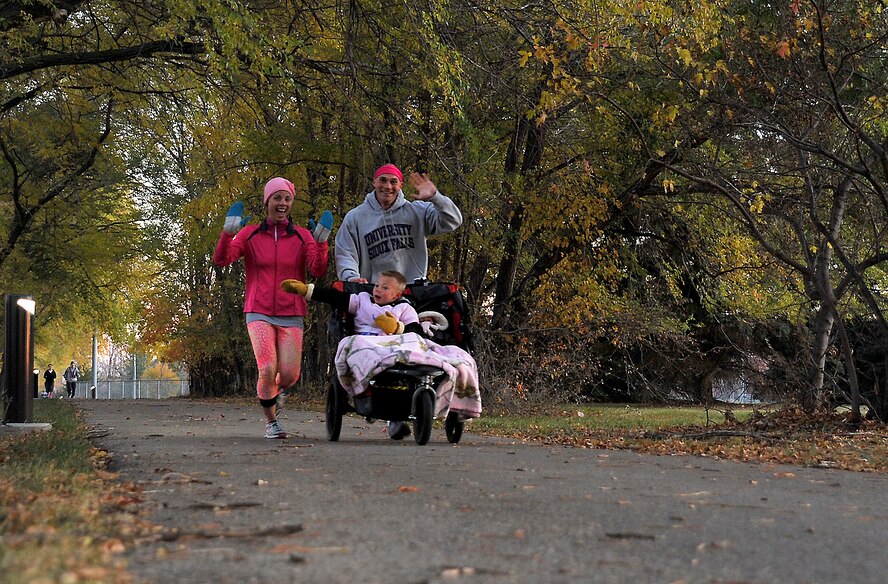 Participants pass in the Pink Run 5K on Grand Forks Air Force Base, North Dakota, Oct. 22, 2015. The pink run was an event sponsored by the 319th Medical Group to promote breast cancer awareness.(U.S. Air Force photo/Airman 1st Class Bonnie Grantham/Released)