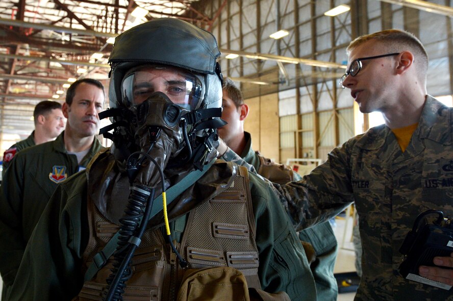 A U.S. Air Force pilot assigned to the 77th Fighter Squadron winks while preparing for aircrew flight equipment decontamination training at Shaw Air Force Base, S.C., Oct. 23, 2015. If contaminated, aircrew will be processed through a lightweight inflatable decontamination system to ensure their safety and health. (U.S. Air Force photo by Senior Airman Diana M. Cossaboom/Released)