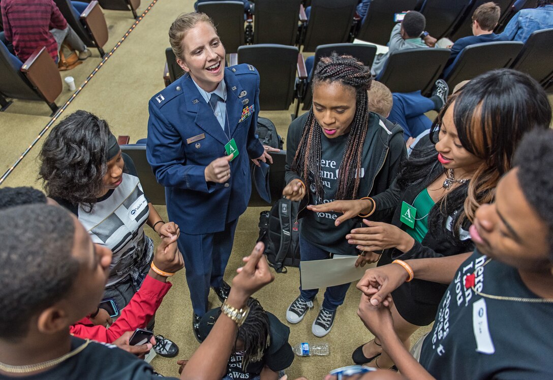 Capt. HaleyArmstrong, flight commander with The United States Air Force Band, engages with Washington, D.C. public school students at a White House conference on the arts andyouth justice. (photo by Senior Master Sgt. Kevin Burns/released)