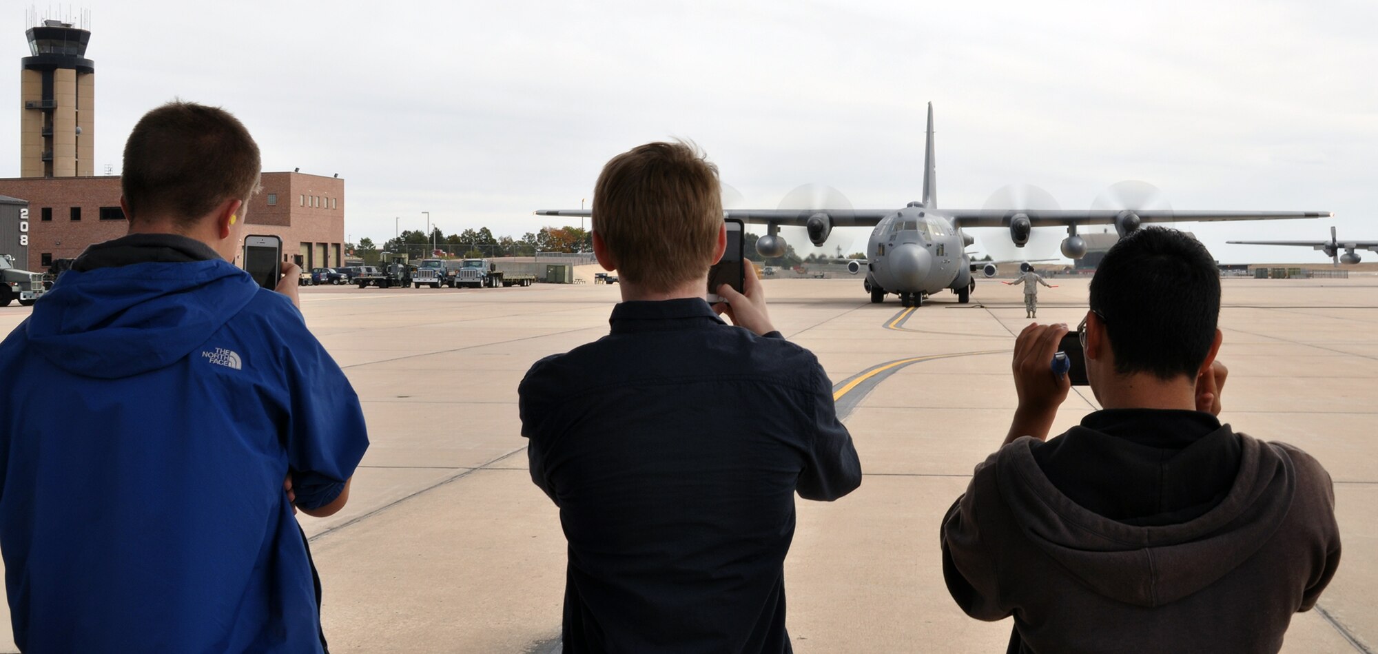 PETERSON AIR FORCE BASE, Colo. -- Students from the Cherry Creek Schools Aviation Technology Program videotape and photograph a C-130H taxiing on the Peterson flight line Oct. 20, 2015. Forty students from the Denver area visited the 302nd Airlift Wing to learn about the wing’s mission and Modular Airborne Fire Fighting System. They also received a static tour of a C-130 aircraft and learned what it is like to be an aircrew member. (U.S. Air Force photo/Master Sgt. Daniel Butterfield)