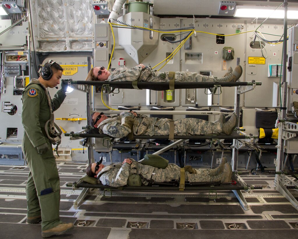 Senior Airman Willson Tsao, an aeromedical service journeyman with the 18th Aeromedical Evacuation Squadron, cares for simulated patients in a C-17 Globemaster III during Joint Readiness Training Center (JRTC) 14-05 training in Alexandria, La., March 13, 2014. The JRTC provides U.S. military units and personnel with realistic pre-deployment training scenarios in all aspects of armed conflict. (U.S. Air Force photo by Tech. Sgt. Matthew Smith)