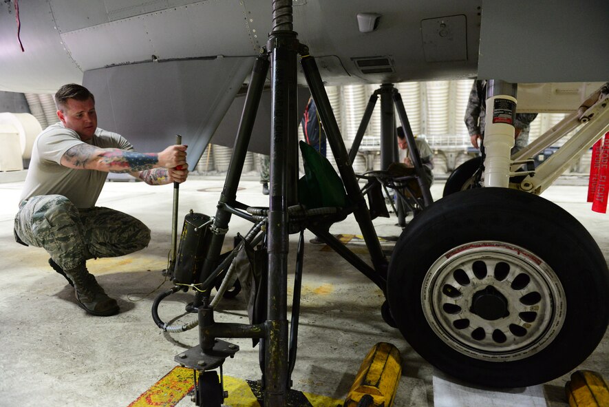 Staff Sgt. James McFadden, 35th Maintenance Group quality assurance manager, positions an aircraft jack beneath the wing of an F-16 Fighting Falcon during a weight and balance check class at Osan Air Base, Republic of Korea, Oct. 14, 2015. The class trained ROK and U.S. quality assurance managers how to properly weigh and balance aircraft using specialized systems. 
(U.S. Air Force photo/Staff Sgt. Amber Grimm)