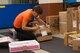 Yoshitomo Shimabukuo, 18th Communications Squadron postal clerk, labels a box number on the side of a received package at the Kadena Post Office Oct. 22, 2015, on Kadena Air Base, Japan. The post office offers a variety of services ranging from mailing out parcels, money orders, parcel pick up and an email notification system, as well as an official mailing center for mission-related shipments. (U.S. Air Force photo by Airman Zackary A. Henry)